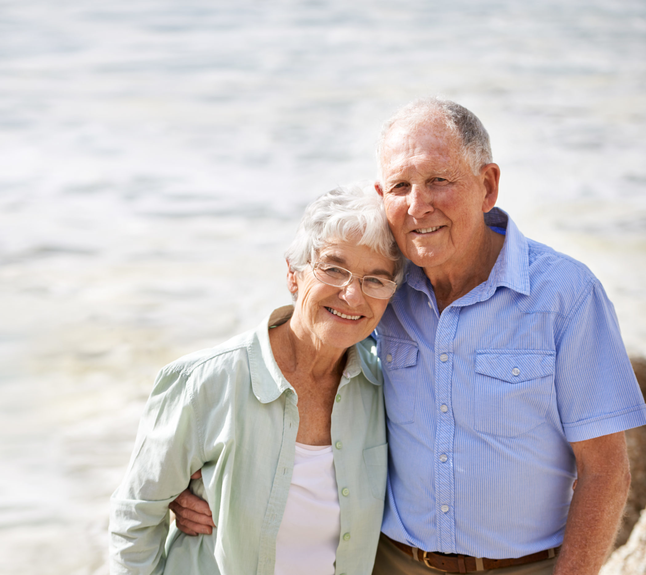 Photo of an elderly man and woman smiling.