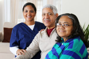 Medical professional smiling with two people.
